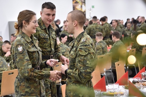 Funkcjonariusze SG podczas dzielenia się opłatkiem Funkcjonariusze SG podczas dzielenia się opłatkiem